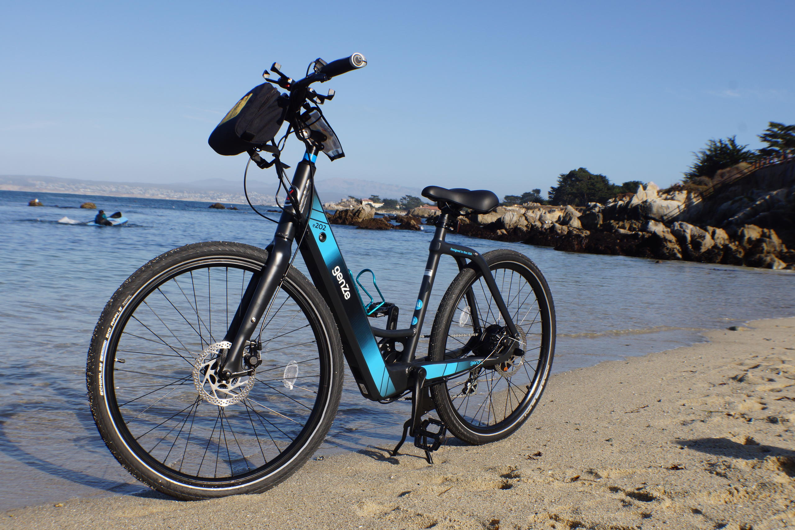 Large group e-bike tour riding together along the Monterey Peninsula coastline